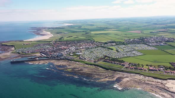 Aerial footage of the seaside coastal town of the village of Seahouses, a large village in the UK