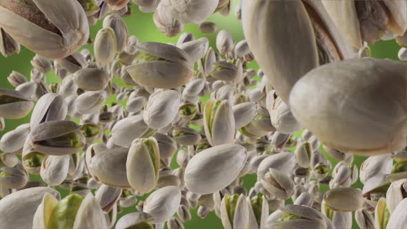 Flying of Pistachios in Green Background alt