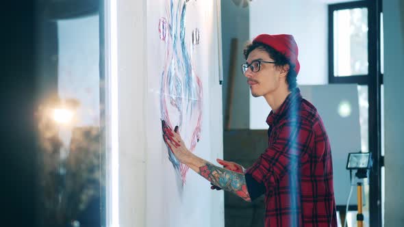 A Man is Painting a Beautiful Picture with Bare Hands alt