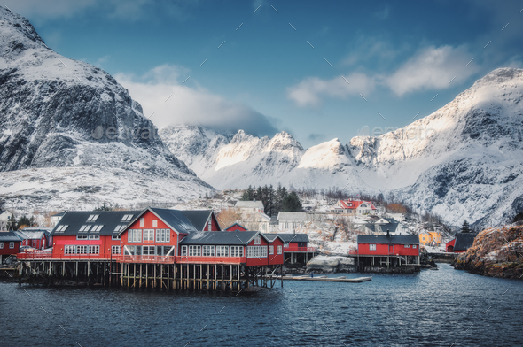 Red traditional rorbuer in small village at sunset in winter - Stock Photo - Images