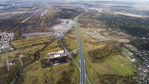 Aerial view of highway interchange Road junction Aerial photo of a highway going through the forest  - Stock Photo - Images