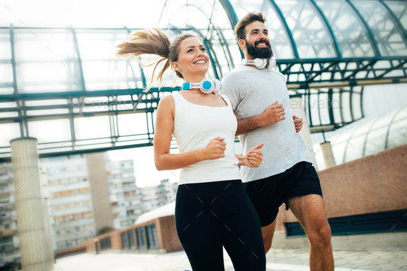 Young fitness couple running in urban area Stock Photo by nd3000 | PhotoDune