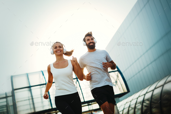 Young fitness couple running in urban area Stock Photo by nd3000 | PhotoDune
