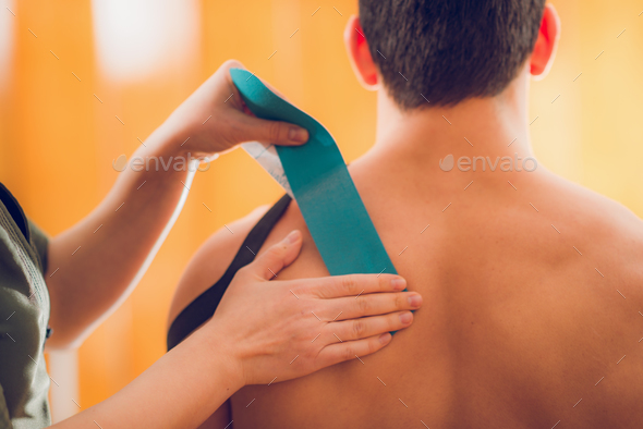 Kinesio taping for shoulder pain - Stock Photo - Images