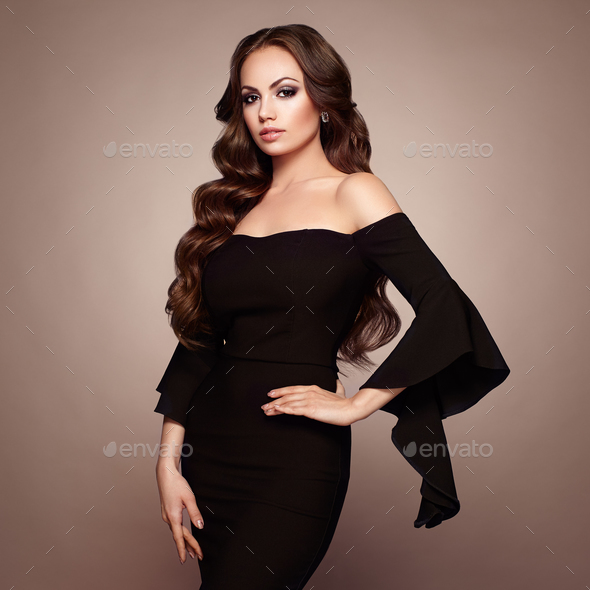 Beautiful woman in elegant black evening dress Stock Photo by heckmannoleg