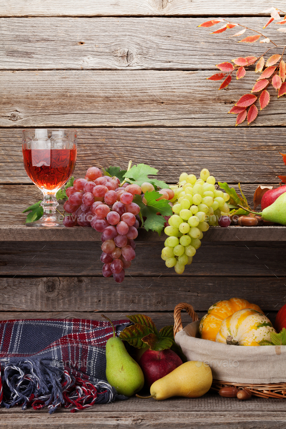 Autumn card with pumpkins, fruits and wine - Stock Photo - Images
