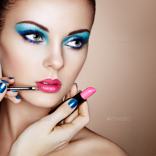 Makeup artist applies lipstick - Stock Photo - Images
