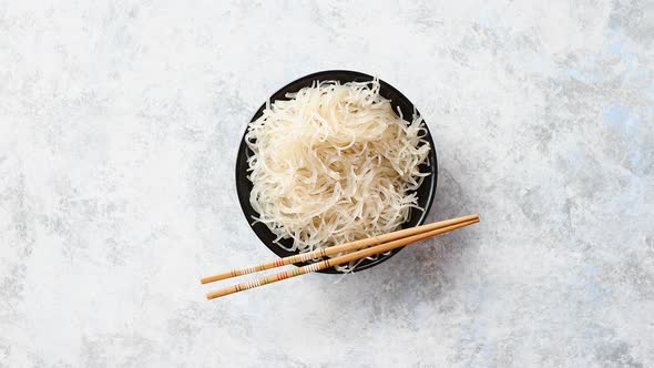 Close Up of Bowl of Noodles with Wooden Chopsticks alt