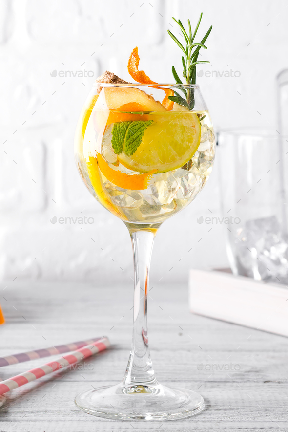 Alcoholic cocktail of the Godfather with orange and ice, isolated on white background