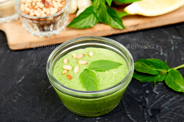 Homemade pesto sauce in glass jar with ingredients. - Stock Photo - Images