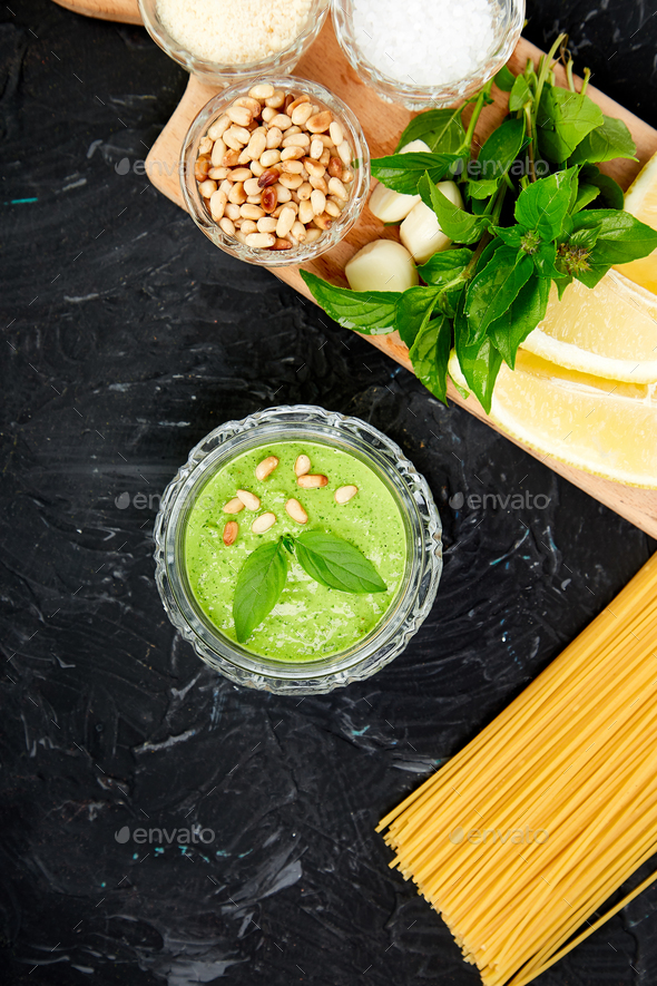 Homemade pesto sauce in glass jar with ingredients. - Stock Photo - Images