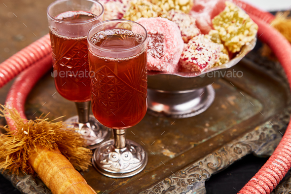 Set of various Turkish delight in bowl on metal tray near hookah tube - Stock Photo - Images