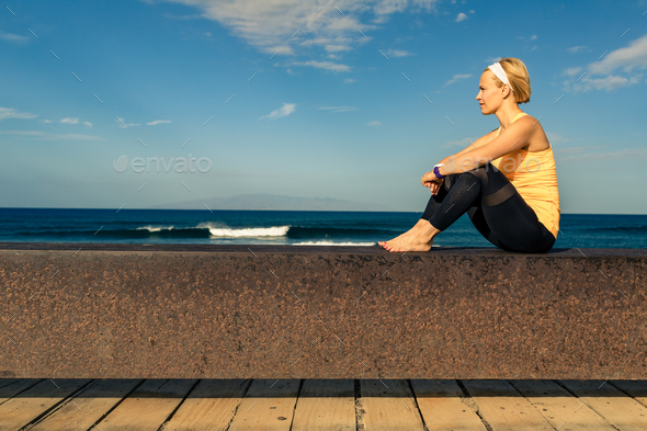 Yoga girl meditating and relaxing in yoga pose, ocean view - Stock Photo - Images
