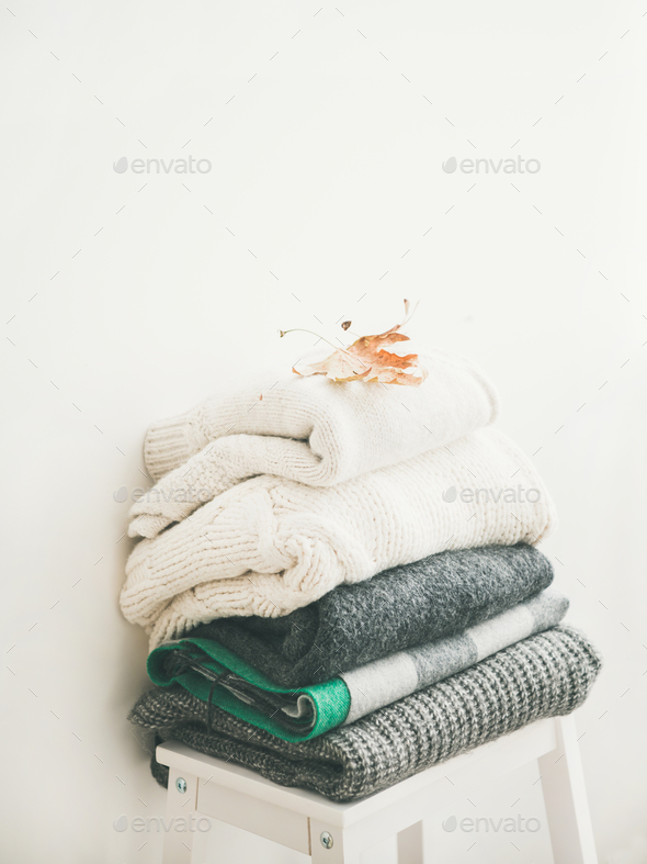 Pile of warm winter sweaters and blankets - Stock Photo - Images