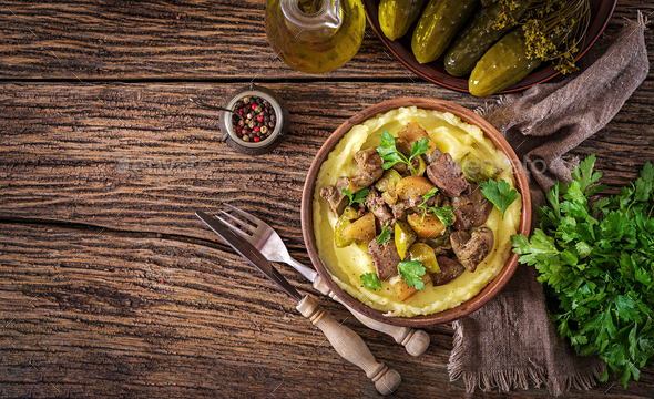 Fried chicken liver with apples, sweet pepper and onions with mashed potatoes - Stock Photo - Images