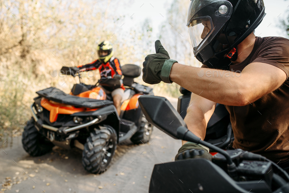 ATV rider showing thumbs up to his partner - Stock Photo - Images