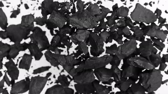 Super Slow Motion Shot of Coal Explosion Isolated on White Background at 1000 Fps. alt