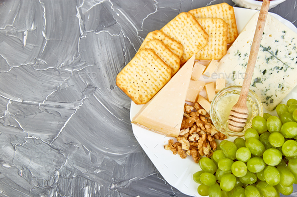 Cheese plate variety, and wine in glasses - Stock Photo - Images