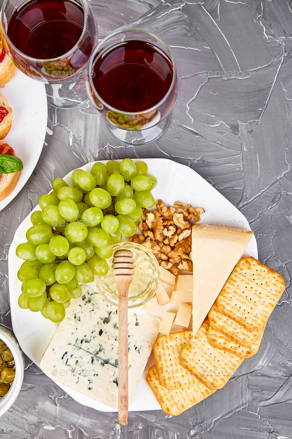 Cheese plate variety, and wine in glasses - Stock Photo - Images
