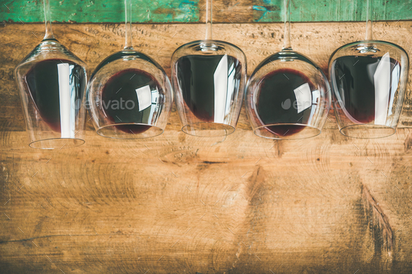 Red wine in glasses over rustic wooden background, copy space - Stock Photo - Images