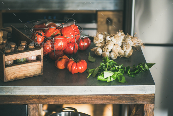Kitchen counter with ingredients for cooking tomato sauce or pasta - Stock Photo - Images