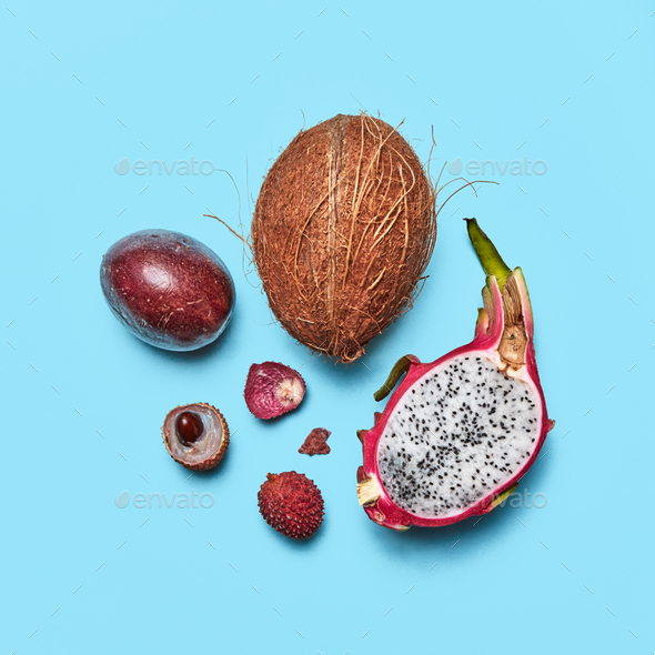 Set of exotic fruit pitahaya, lychee, passion fruit, coconut on a blue background with space for