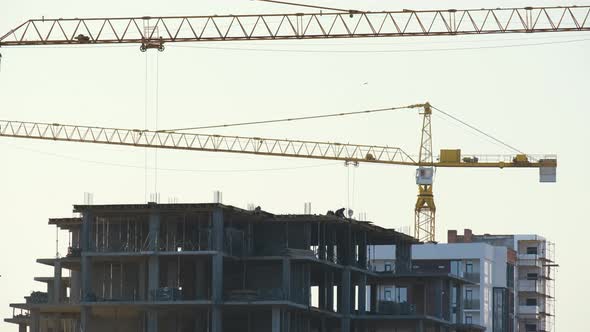Aerial View of Tower Cranes and High Residential Apartment Buildings Under Construction alt