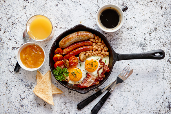 Delicious english breakfast in iron cooking pan - Stock Photo - Images