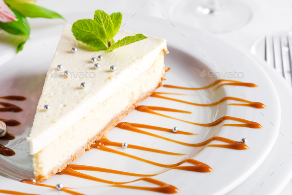Classical New York Cheesecake with mint on white plate close up - Stock Photo - Images