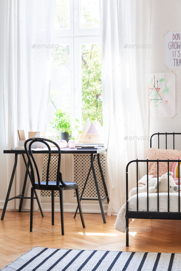 Black Chair At Desk Next To Bed In Teenager S Room Interior With