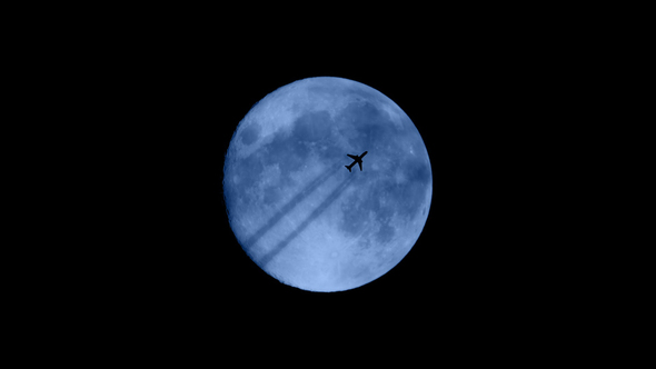 Plane Flies In Front Of Moon alt