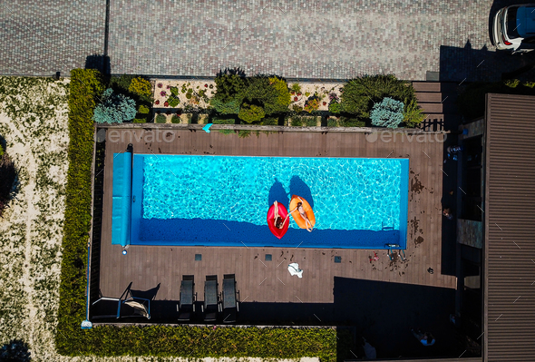 Two girls are swimming in the pool Stock Photo by simbiothy | PhotoDune