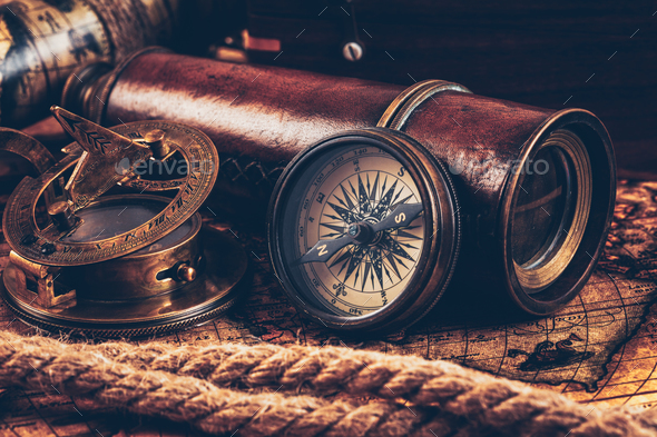 Old vintage compass on ancient map - Stock Photo - Images