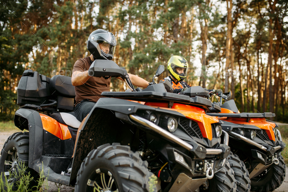 Download Two quad bike riders in helmets closeup, side view Stock ...