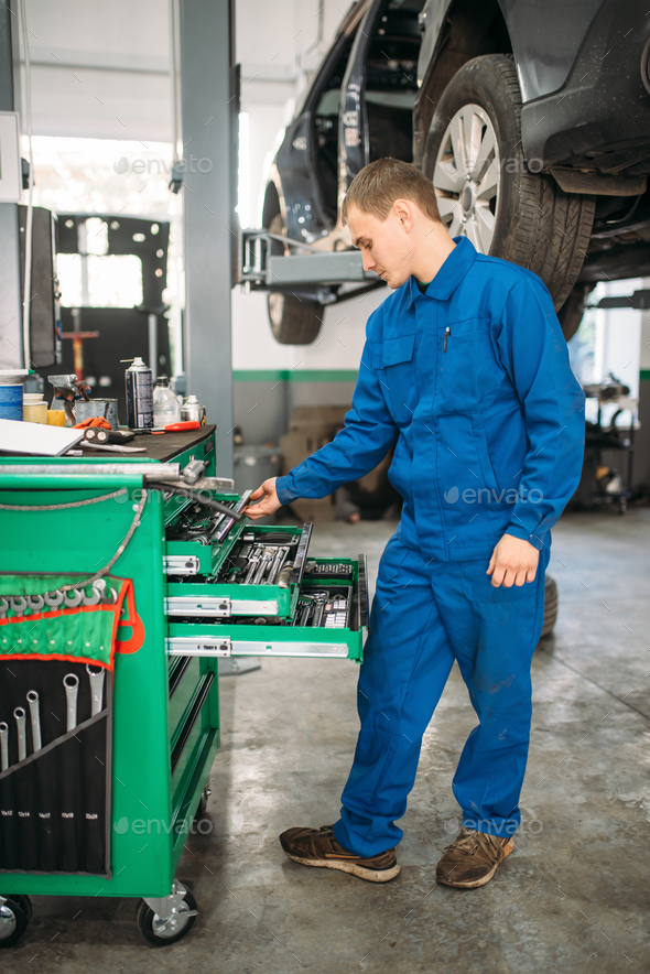 Repairman reaching for the wrench in tool box - Stock Photo - Images