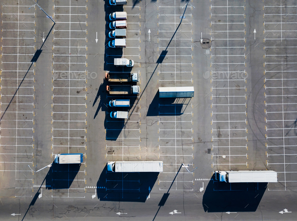 Aerial view from a drone of a parking lot with a multitude of trucks on a sunny day. Top view - Stock Photo - Images