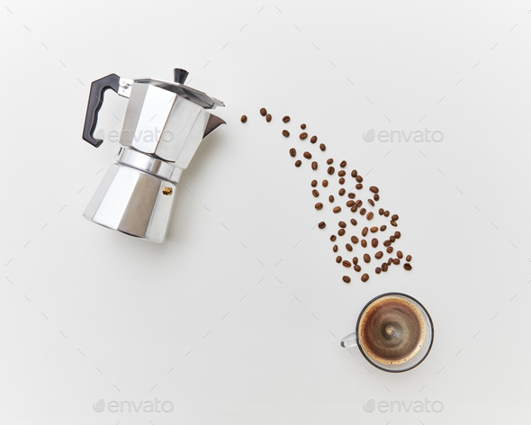 Coffee beans pour in a cap with drink from a metal coffee maker on a white background. Flat lay - Stock Photo - Images