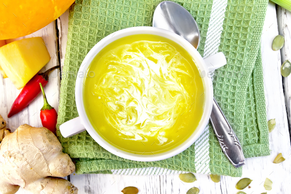 Soup-puree pumpkin with cream in white bowl on green napkin top - Stock Photo - Images