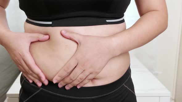 Women worry and touching their belly overweight diet and weight loss. Healthcare and good body shape alt