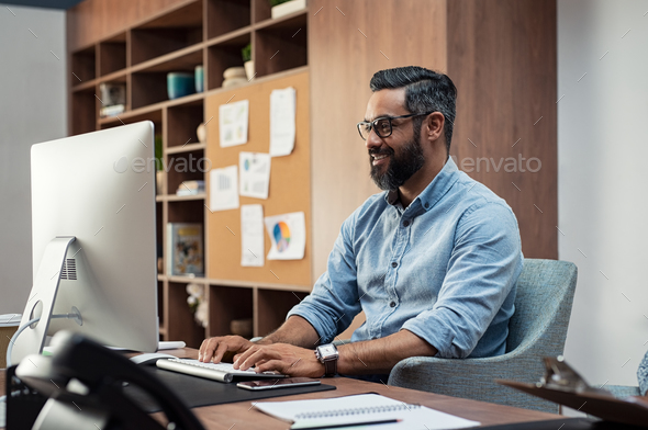 Creative man working on computer - Stock Photo - Images