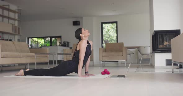 Beautiful Girl Using Smartphone After Fitness Workout at Home