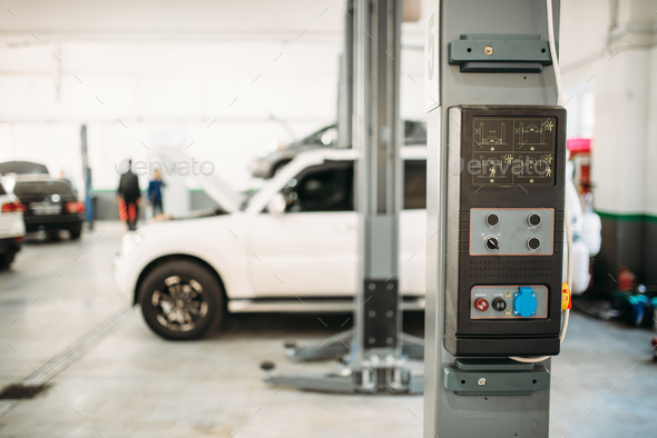 Car on lift jack, service interior on background - Stock Photo - Images