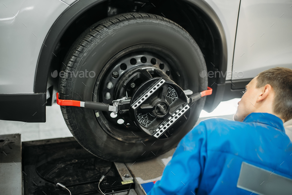 Mechanic adjusts collapse of convergence stand - Stock Photo - Images