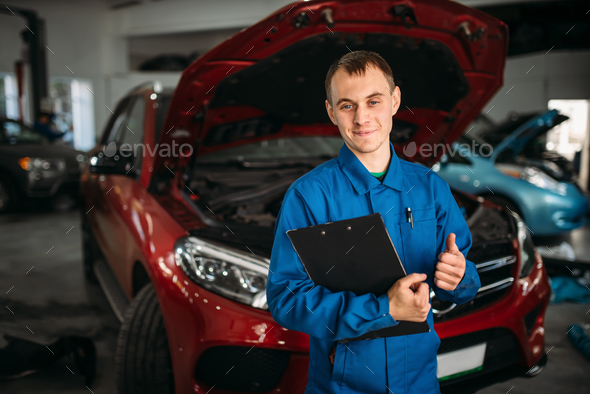 Technician with notebook, car with opened hood - Stock Photo - Images