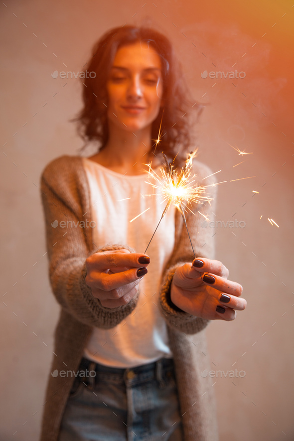 Close-up of sparkler in woman hands - Stock Photo - Images