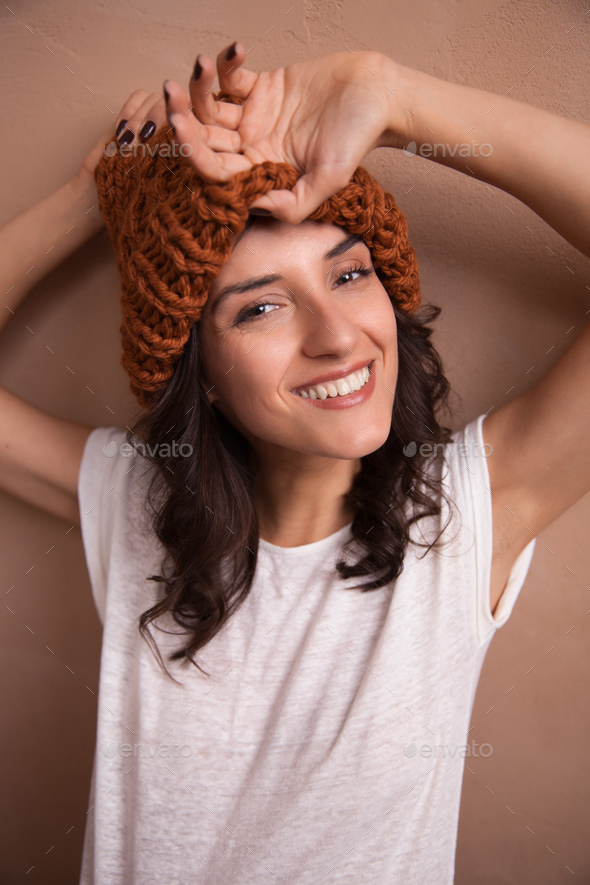 Happy smiling woman in knitted hat - Stock Photo - Images