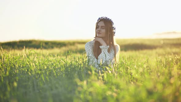 A Young Ukrainian Girl Poses in a Young Wheat Field alt