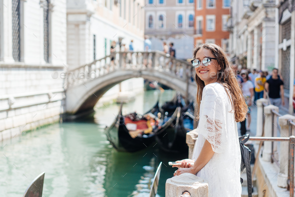 Young girl posing on camera in venetian streets - Stock Photo - Images