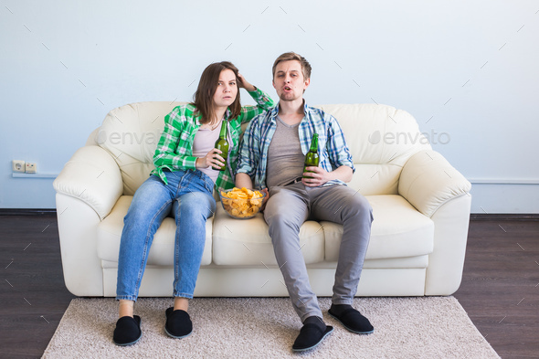Friends watch sports on TV together, drink beer. Fans cheer for their team - Stock Photo - Images