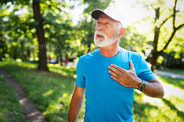 Mature man exercising outdoors to prevent cardiovascular diseases and heart attack - Stock Photo - Images
